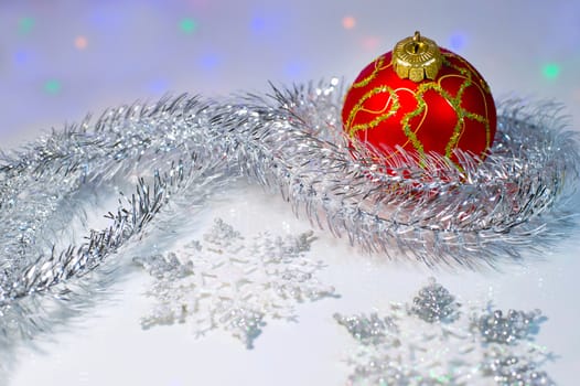 Christmas still life with red Christmas balls, tinsel and snowflakes
