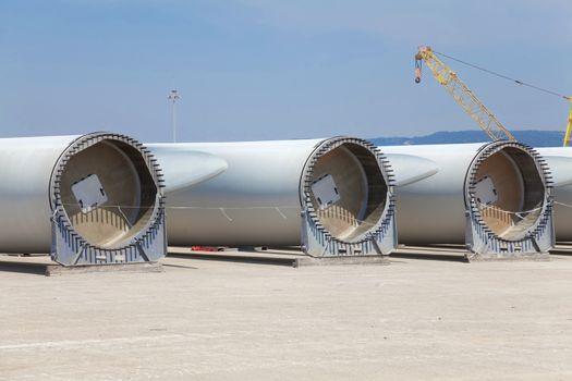 Giant wind turbine awaiting assembly at wind farm.