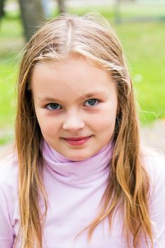 Cute girl with blond long hair and blue eyes