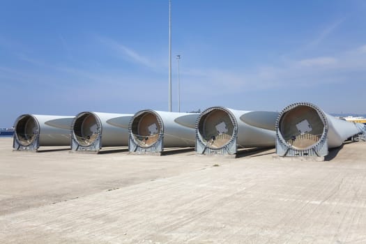 Giant wind turbine awaiting assembly at wind farm.