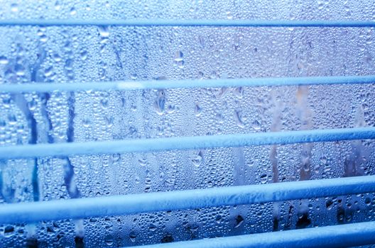 closeup of natural water drop on glass background