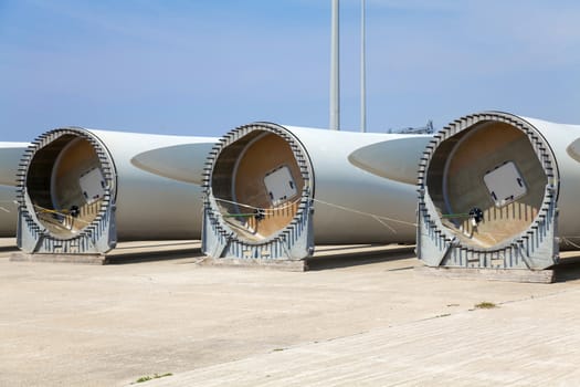 Giant wind turbine awaiting assembly at wind farm.