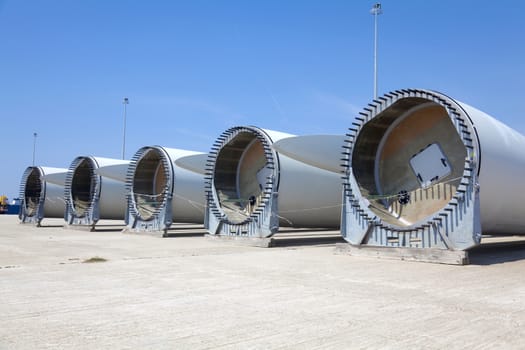 Giant wind turbine awaiting assembly at wind farm.