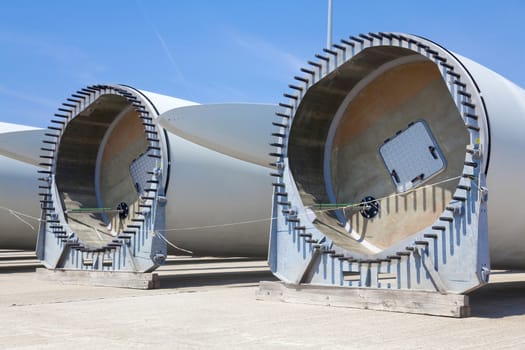 Giant wind turbine awaiting assembly at wind farm.