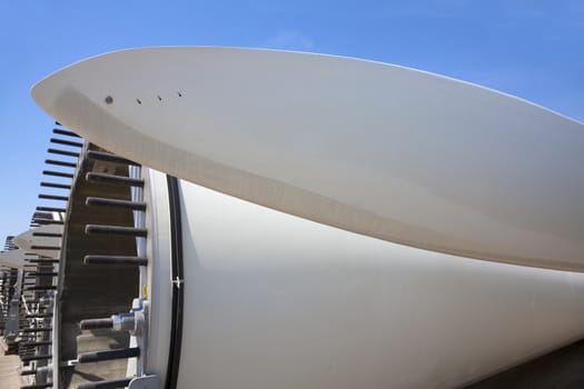 Giant wind turbine awaiting assembly at wind farm.