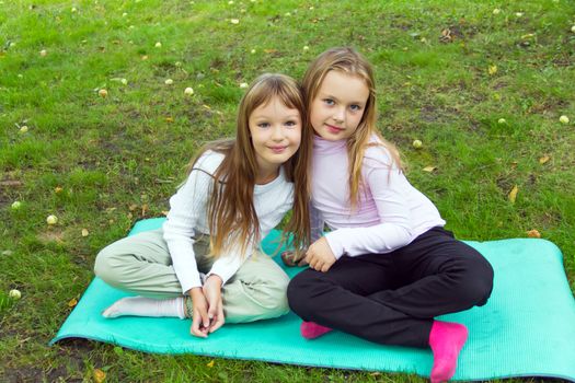 Photo of two playing girls in summer