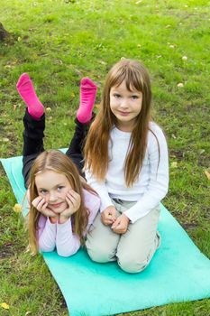 Photo of two playing girls in summer