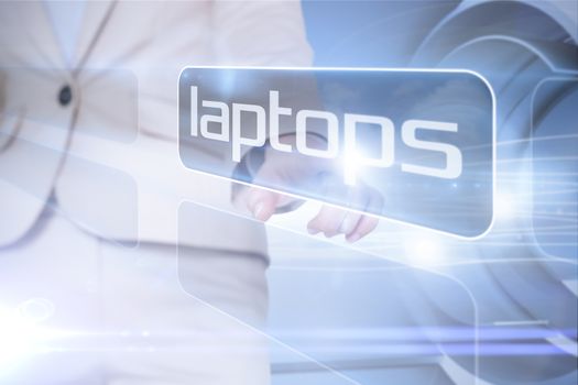 Businesswoman pointing to word laptops against abstract white cloud design