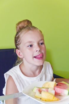 Portrait of eating girl with put out tongue