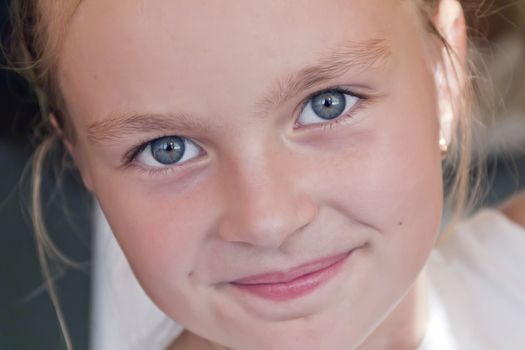 Cute girl with blond long hair and blue eyes