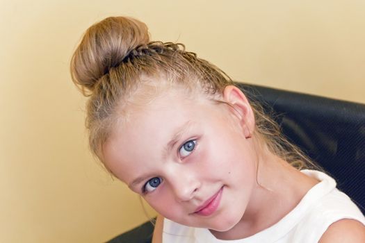 Cute girl with blond long hair and blue eyes