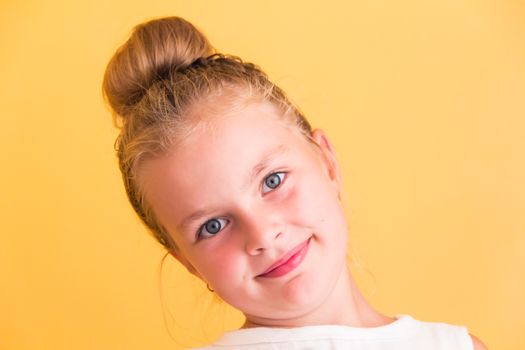 Cute girl with blond long hair and blue eyes