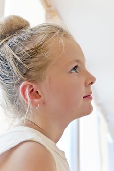 Cute girl with blond long hair and blue eyes