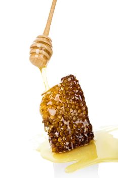 Luxurious honey background. Honey dropping on honey comb isolated on white background. Healthy honey eating. 