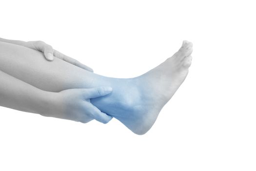 Ankle pain. Female holding her ankle with highlighted pain area isolated on white background.