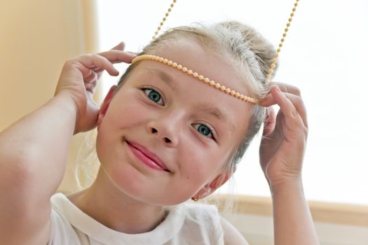 Photo of cute playing girl with blond hair