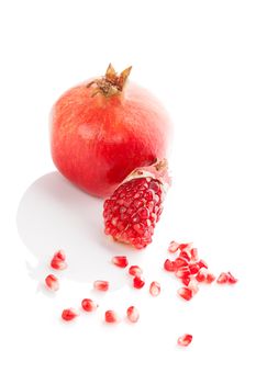 Pomegranate isolated on white background. Healthy fruit eating.