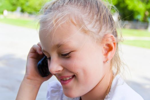 Photo of cute girl talking by cellular