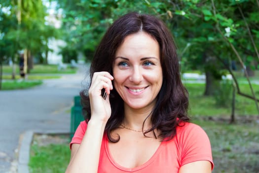Photo of the brunette talking by cellular