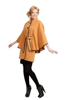 The girl in a yellow autumn coat on a white background