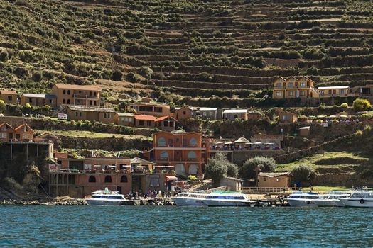 YUMANI, BOLIVIA - NOVEMBER 5, 2014: The harbor and terraces on the hillside of Yumani on the southern part of Isla del Sol (Island of the Sun), a popular travel destination in Lake Titicaca, on November 5, 2014 in Yumani, Bolivia  