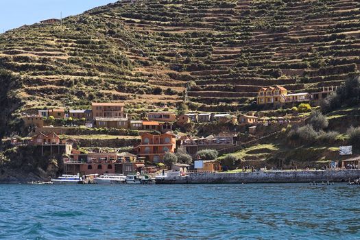 YUMANI, BOLIVIA - NOVEMBER 5, 2014: The harbor and terraces on the hillside of Yumani on the southern part of Isla del Sol (Island of the Sun), a popular travel destination in Lake Titicaca, on November 5, 2014 in Yumani, Bolivia  