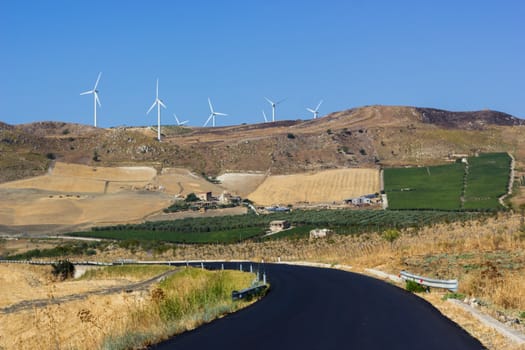 hilly landscape where there is a wind power plant 