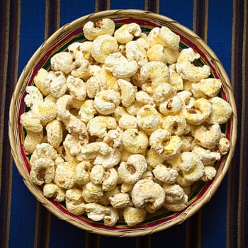 Sweetened popped white corn called Pasancalla eaten as snack in Bolivia served in a woven basket, photographed with natural light