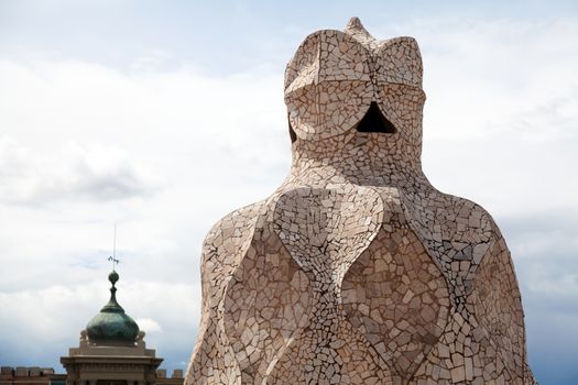 BARCELONA - APR 14: Chimneys covered with ceramic fragments that look like helmets at La Pedrera (Casa Mila) on Apr 14, 2012 in Barcelona, Spain. Casa Mila was built in 1910 by Antoni Gaudi.