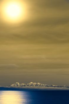 Lake Titicaca and the snow-capped mountains of the Andes photographed from the Isla del Sol (Island of the Sun) at night with the full moon shining 