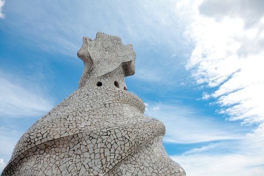 BARCELONA - APR 14: Chimneys covered with ceramic fragments that look like helmets at La Pedrera (Casa Mila) on Apr 14, 2012 in Barcelona, Spain. Casa Mila was built in 1910 by Antoni Gaudi.