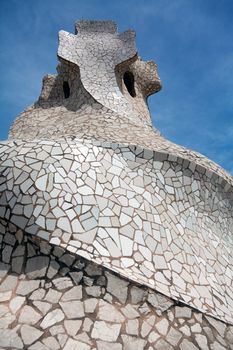BARCELONA - APR 14: Chimneys covered with ceramic fragments that look like helmets at La Pedrera (Casa Mila) on Apr 14, 2012 in Barcelona, Spain. Casa Mila was built in 1910 by Antoni Gaudi.