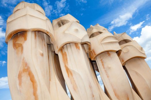 BARCELONA, SPAIN - APR 14: Chimneys like masked soldiers on the roof of La Pedrera or Casa Mila designed by Antoni Gaudi, on April 14, 2012 in Barcelona, Spain. La Pedrera was built in 1906-1910.