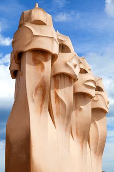 BARCELONA, SPAIN - APR 14: Chimneys like masked soldiers on the roof of La Pedrera or Casa Mila designed by Antoni Gaudi, on April 14, 2012 in Barcelona, Spain. La Pedrera was built in 1906-1910.