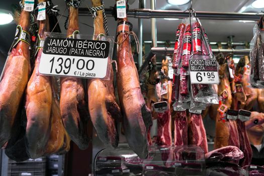 BARCELONA, SPAIN - APRIL 14: Jamon market in La Boqueria market on April 14, 2012 in Barcelona, Spain. La Boqueria is one of the oldest markets in Europe that still exists. It was established in 1217.