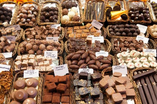 BARCELONA, SPAIN - APRIL 14: Famous La Boqueria market with nuts, chocolate delicacies, fruit jellies and dry fruits on April 14, 2012 in Barcelona, Spain. One of the oldest markets in Europe that still exist. Established 1217.