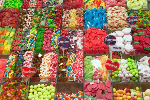 BARCELONA, SPAIN - APRIL 14: Famous La Boqueria market with nuts, chocolate delicacies, fruit jellies and dry fruits on April 14, 2012 in Barcelona, Spain. One of the oldest markets in Europe that still exist. Established 1217.