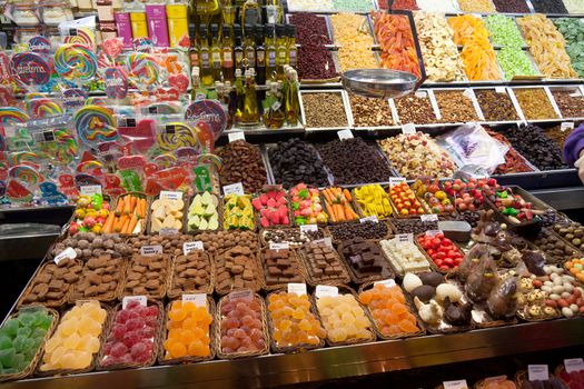 BARCELONA, SPAIN - APRIL 14: Famous La Boqueria market with nuts, chocolate delicacies, fruit jellies and dry fruits on April 14, 2012 in Barcelona, Spain. One of the oldest markets in Europe that still exist. Established 1217.