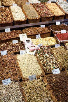 BARCELONA, SPAIN - APRIL 14: Famous La Boqueria market with nuts, chocolate delicacies, fruit jellies and dry fruits on April 14, 2012 in Barcelona, Spain. One of the oldest markets in Europe that still exist. Established 1217.