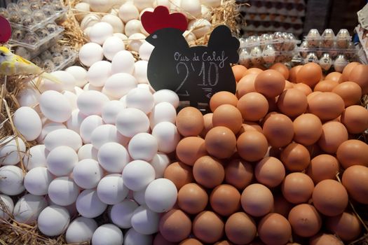 BARCELONA, SPAIN - APRIL 14: Tourists shop with eggs in famous La Boqueria market on April 14, 2012 in Barcelona, Spain. One of the oldest markets in Europe that still exist. Established 1217.