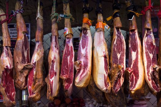 BARCELONA, SPAIN - APRIL 14: Jamon market in La Boqueria market on April 14, 2012 in Barcelona, Spain. La Boqueria is one of the oldest markets in Europe that still exists. It was established in 1217.