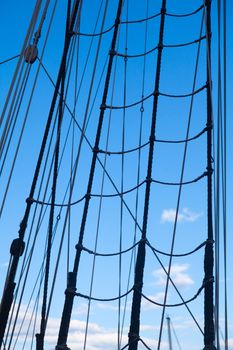 Marine rope ladder at pirate ship. Sea hemp ropes on the old nautical vessel. Ladder upstairs on the mast