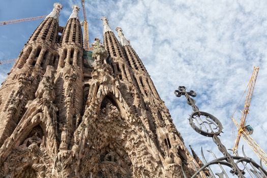 Sagrada Familia is a large Roman Catholic church in Barcelona, Catalonia, Spain, designed by Catalan architect Antoni Gaudi (1852-1926). Though construction of Sagrada Familia had commenced in 1882, Gaudi became involved in 1883, taking over the project and transforming it with his architectural and engineering style-combining Gothic and curvilinear Art Nouveau forms.