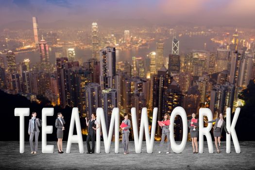 Concept of teamwork with group of business people stand with 3d text. 