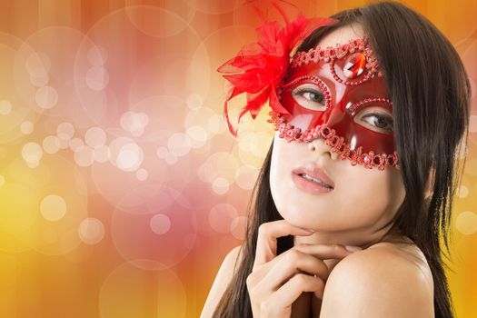 Portrait of Asian young beautiful woman in a carnival mask, closeup portrait.