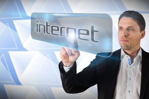 Businessman pointing to word internet against abstract glowing triangles