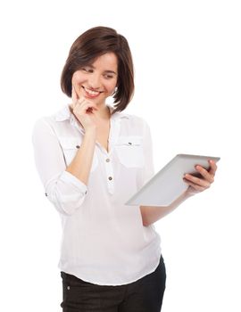 Young brunette holding and reading something on an electronic tablet, isolated on white