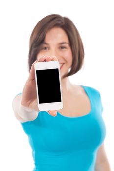 Young smiling woman showing a phone, communication concept, copy space, isolated on white