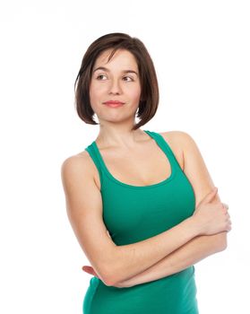 Portrait of a young woman looking relaxed, confident, with her arms crossed, isolated on white