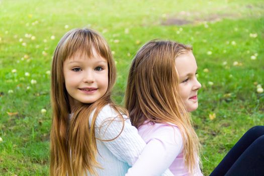 Photo of two playing girls in summer